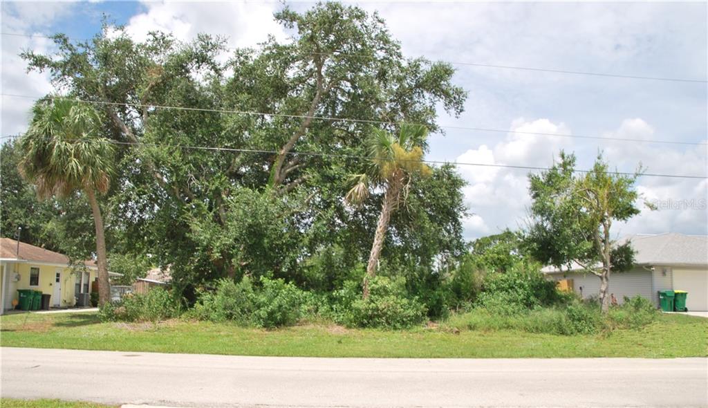 Front of Vacant Land with Partial View of Adjoining Properties.