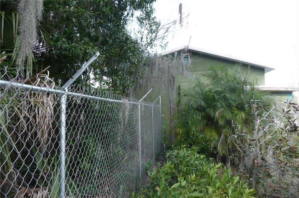FENCE SHOWS HOW BUILDING IS SPLIT BETWEEN 327 AND 323 PINE ST