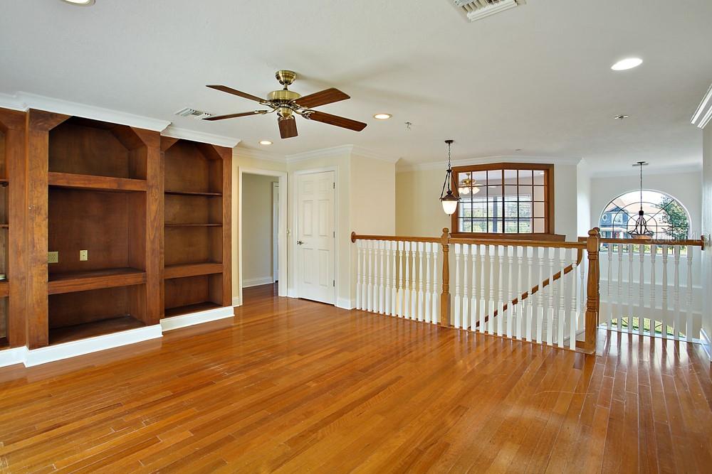 Second Story Family Room.  Overlooking foyer to the front and Pool / Canal to the rear!   Balcony Connecting to master bedroom overlooks pool and canal to the rear.
