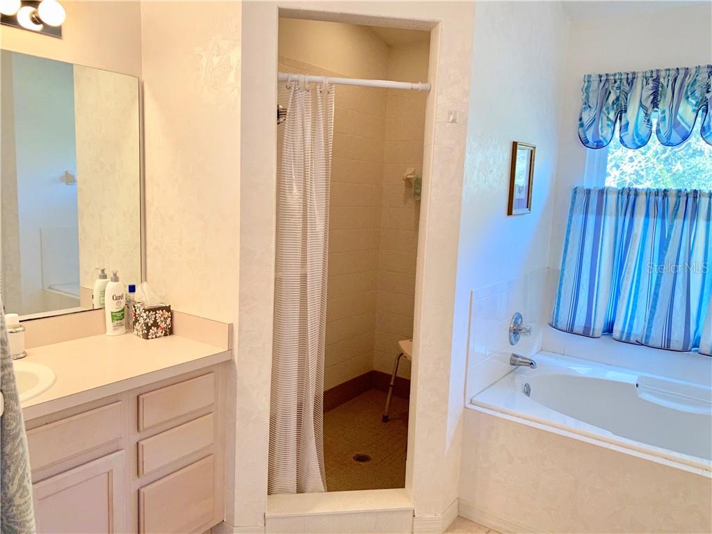 LARGE WALK IN SHOWER AND HER VANITY