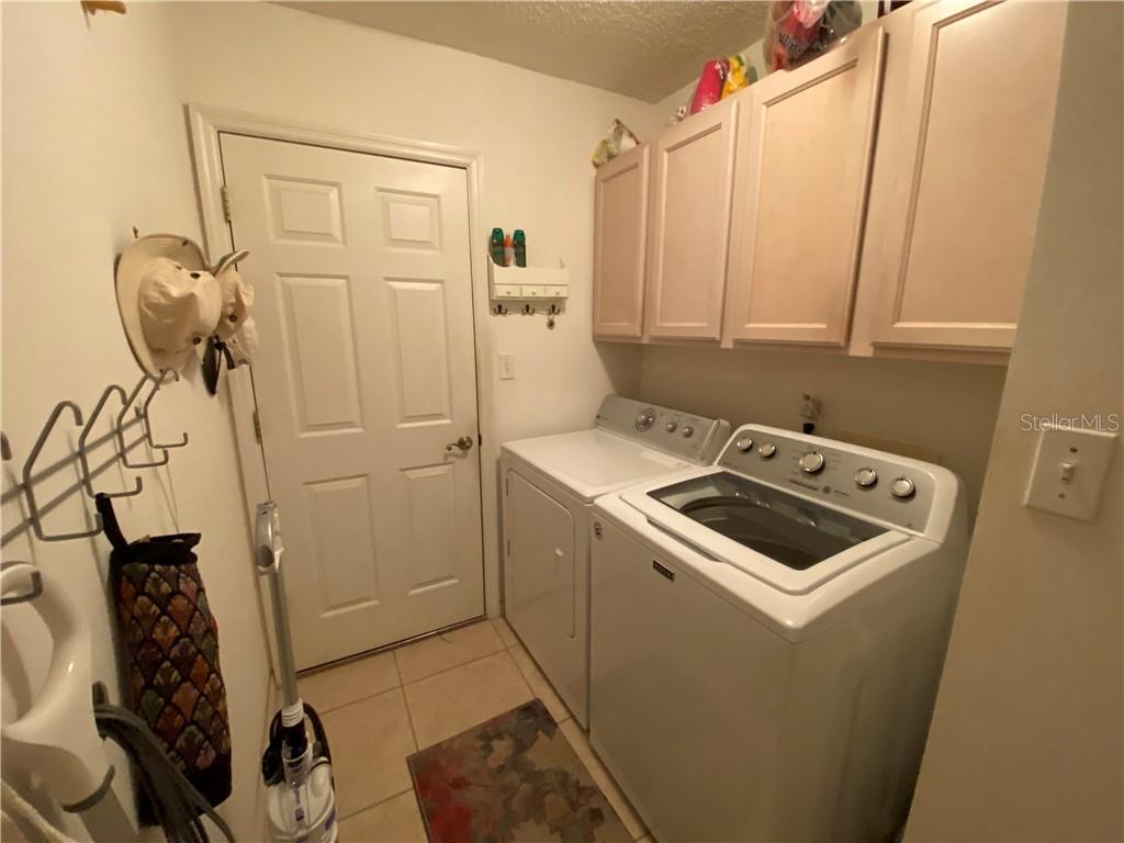 INSIDE LAUNDRY ROOM WITH MAYTAG WASHER AND DRYER