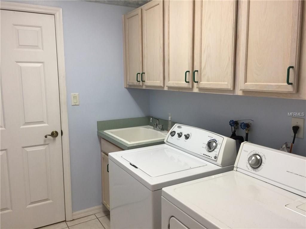 UTILITY ROOM WITH PLENTY OF CABINETS, SINK, AND WALKIN PANTRY