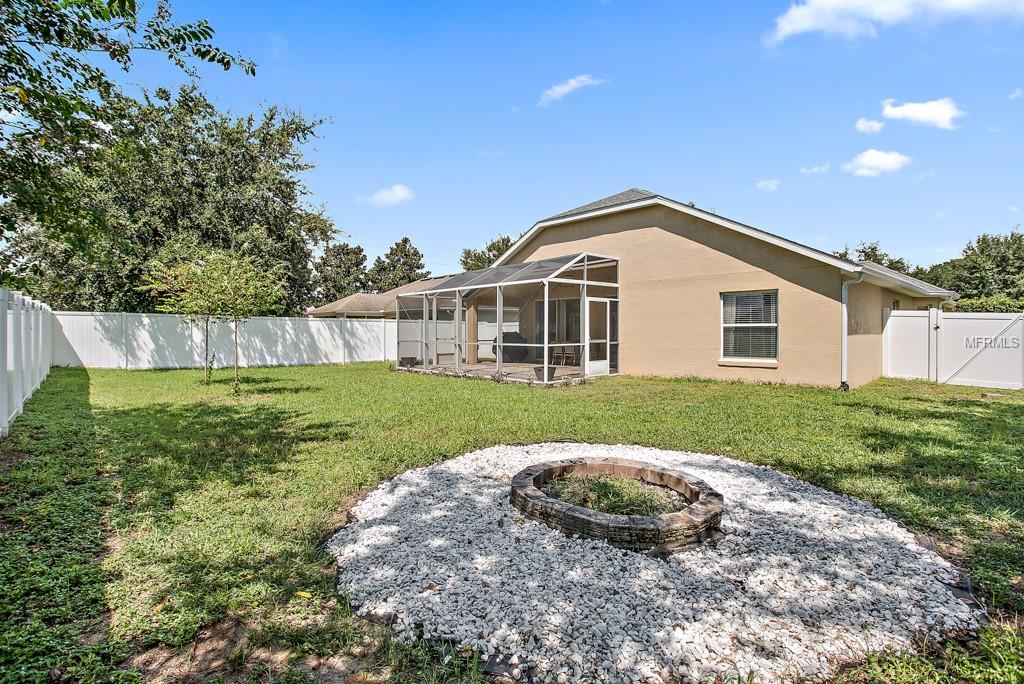 Fenced backyard with firepit