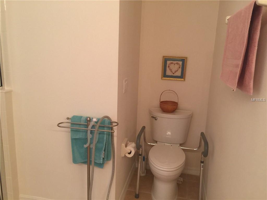 TOILET AREA TUCKED DISCREETLY IN THE CORNER OF THE MASTER BATH