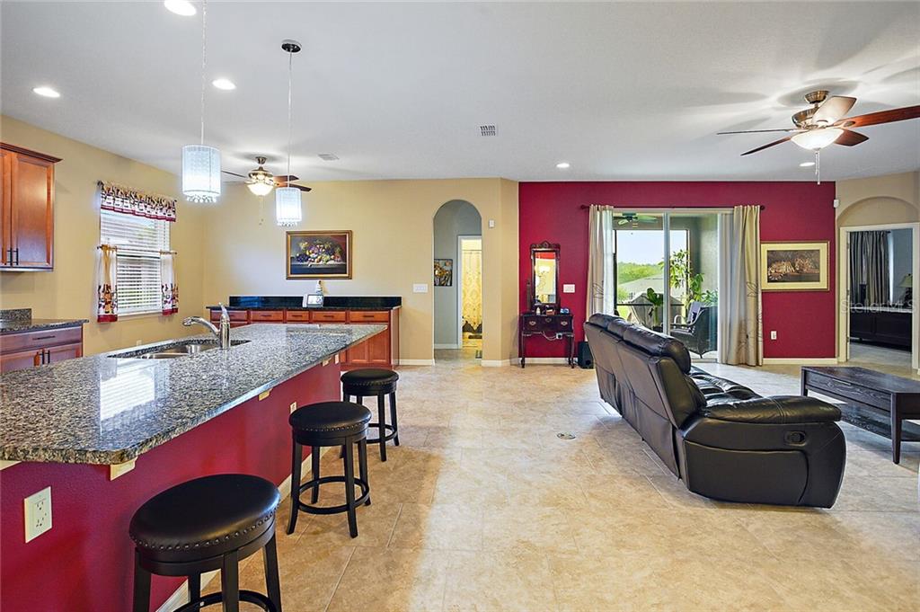 Notice the island with granite counter-tops and the ample area for entertaining