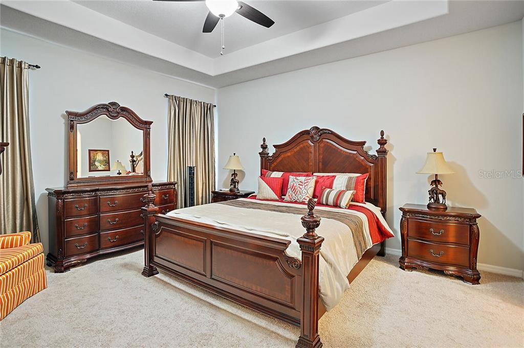 Spacious and dreamy Master Suite offers the flair of a coffered ceiling. Upgraded ceiling fan and double windows to set in our Florida sunshine.