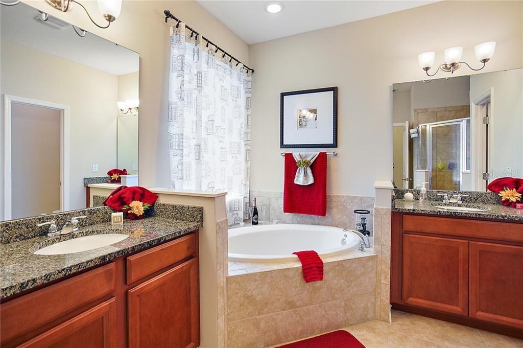 Luxurious Master En-Suite with double sinks, granite counter tops, and a soaking tub.