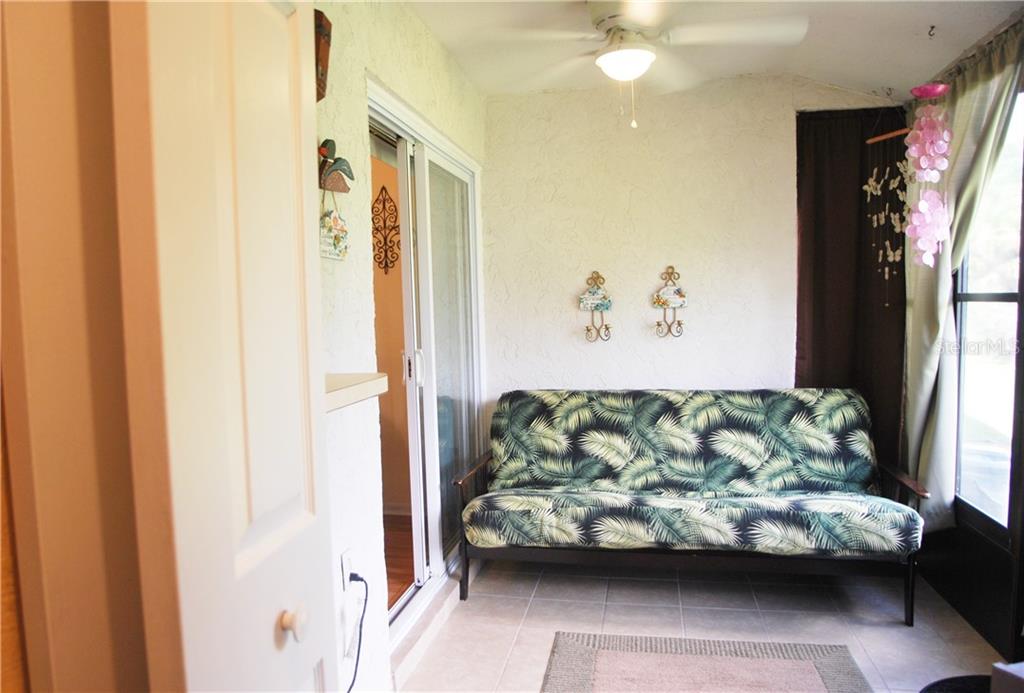 Enclosed Lanai with new Ceramic Flooring, Vinyl Windows, and Door.