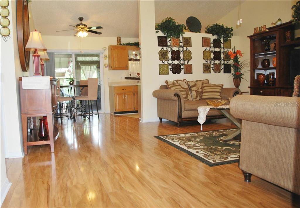 As you enter, enjoy the open feeling of this gorgeous villa! Check out the beautiful, shiny laminate flooring , and notice how immaculately clean everything in this home is.