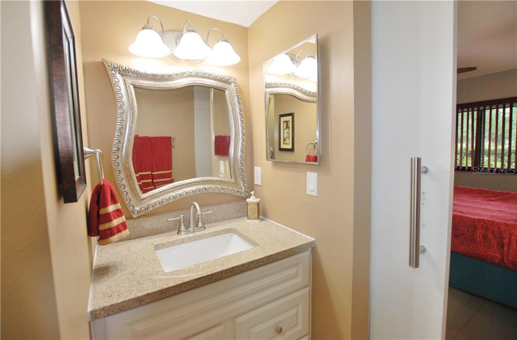 Granite counter-tops and a contemporary mirror add drama to your Master Bath.