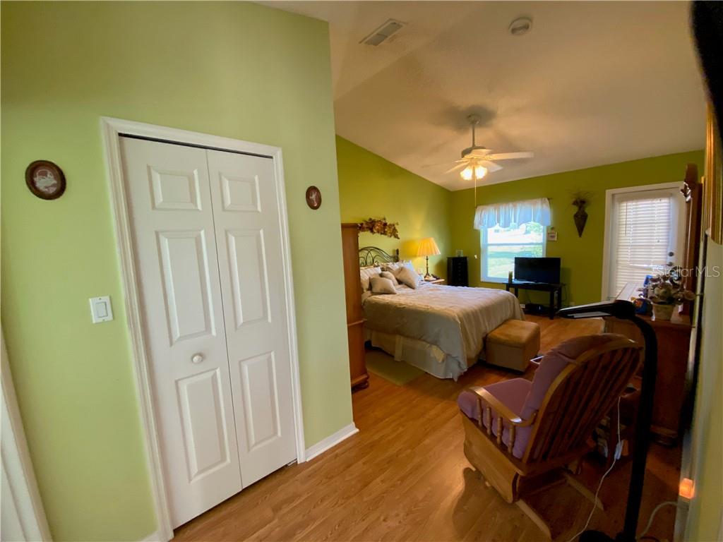 LAMINATE WOOD FLOORS IN LARGE MASTER BEDROOM