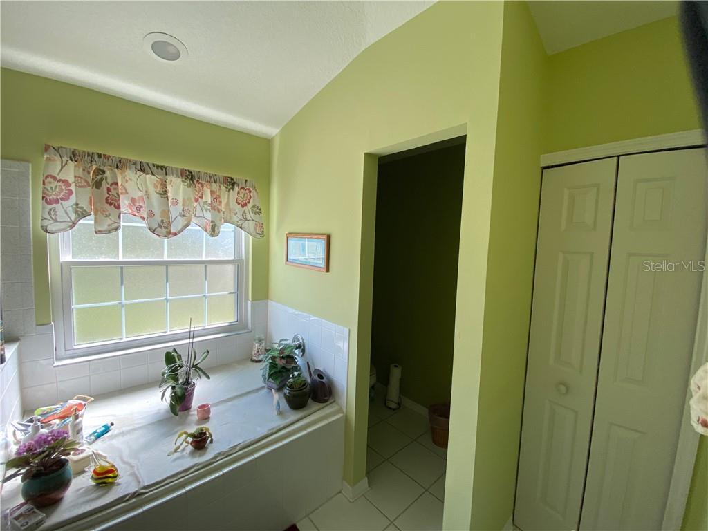 MASTER BATH LOOKING INTO WATER CLOSET(BEAUTIFUL GARDEN TUB UNDER COVER)