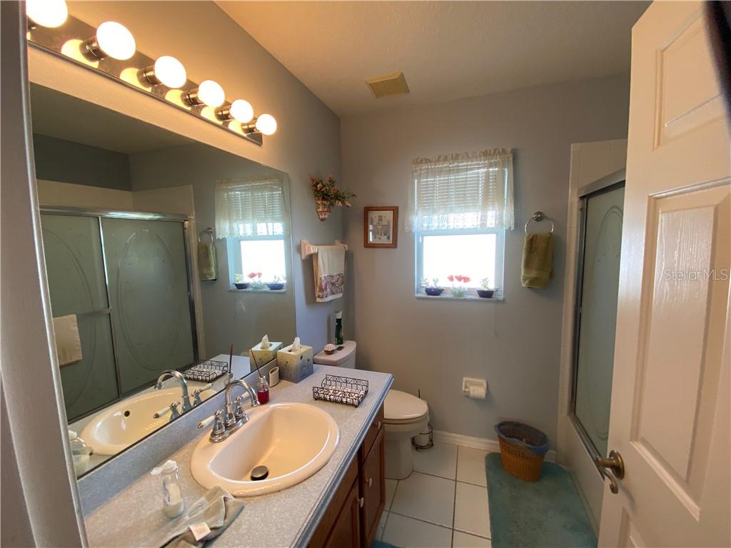 GUEST BATH WITH BEAUTIFUL POURED STONE COUNTERTOPS