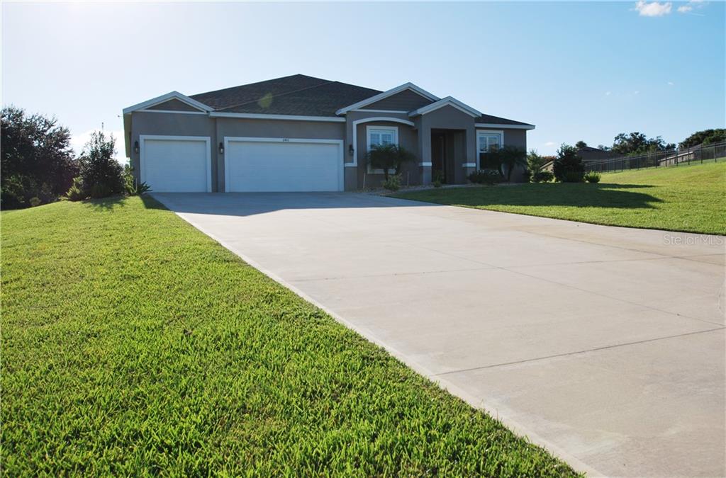 Beautiful curb appeal with a wide driveway and 3-car garage.