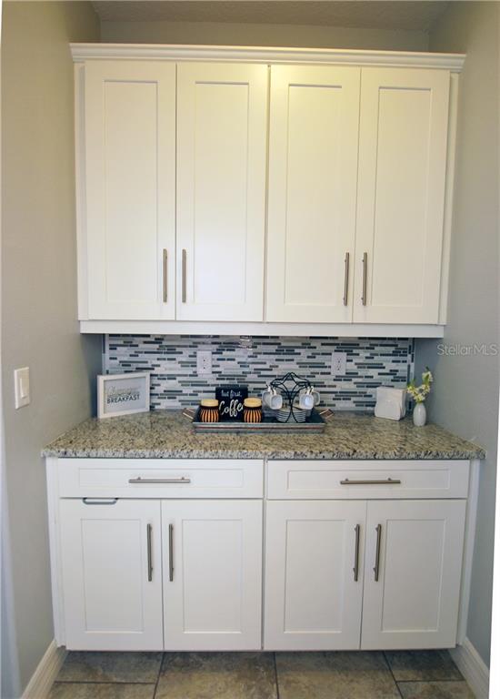The Butler's Pantry connects the Kitchen to the formal Dining Room and is perfect for a coffee bar or a dry bar, or a prep area.