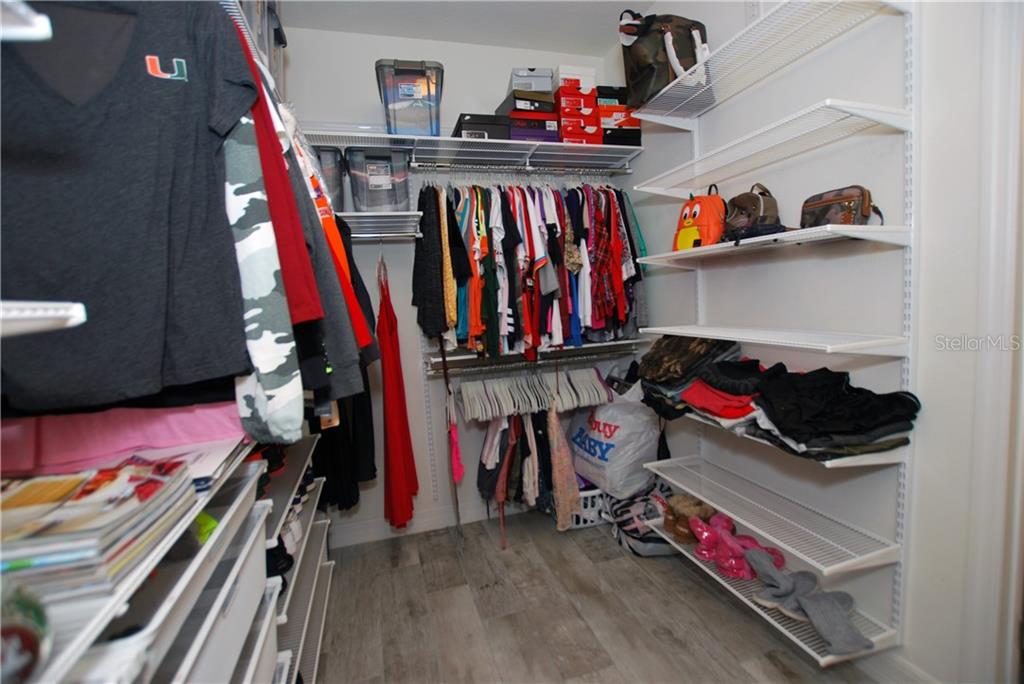 Plenty of room for clothes and shoes in this newly installed Elfa closet system.