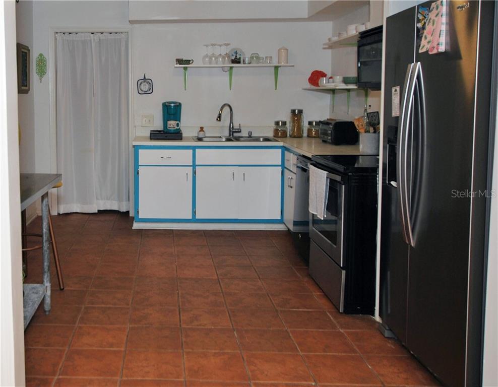 Kitchen with Open Shelves. The Butler's Pantry behind those curtains has all the room you need for storage.