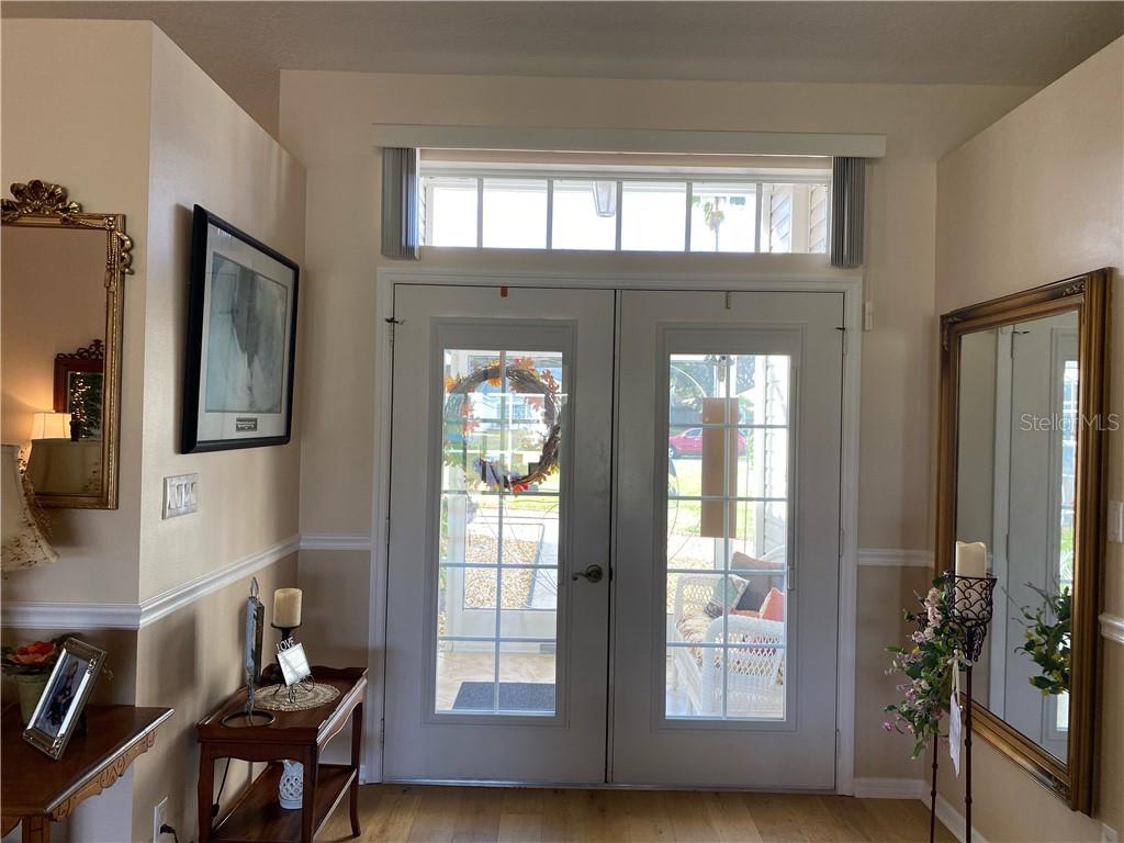 TRANSOM WINDOW ABOVE TWO ENTRANCE DOORS TO FOYER