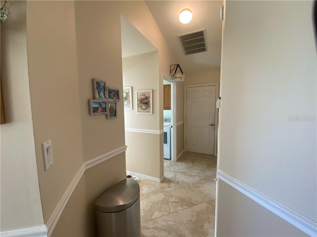 BACK HALLWAY LEADING TO POWDER ROOM, LAUNDRY ROOM AND GARAGE