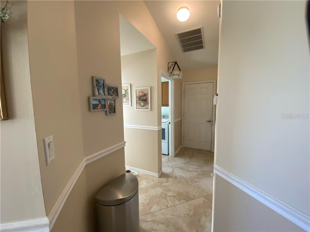 NOTICE THE BEAUTIFUL CERAMIC TILE WHICH MATCHES IN KITCHEN, ENTRY FOYER, AND LANAI