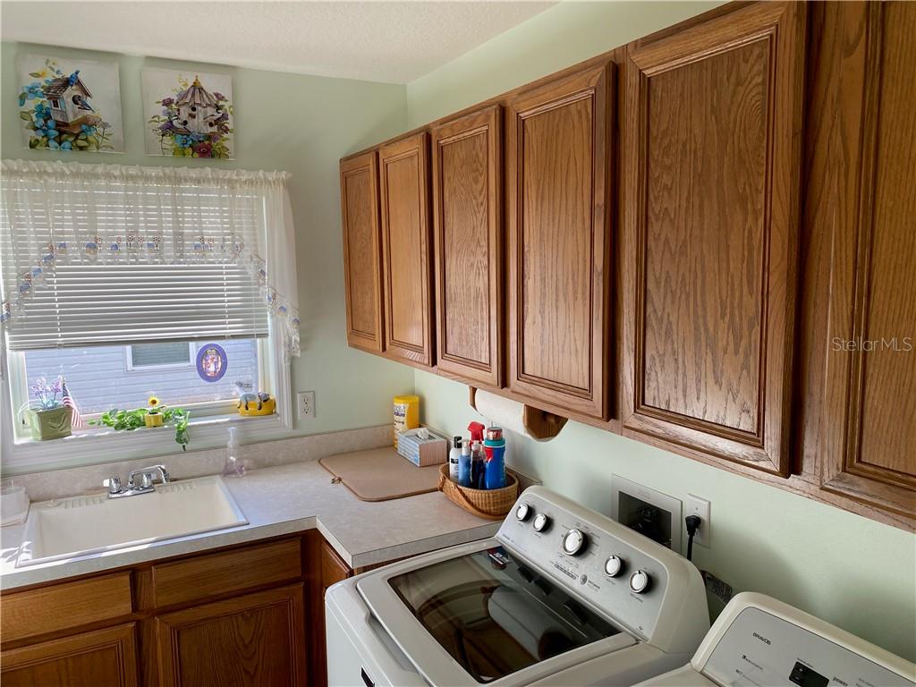 LAUNDRY ROOM HAS PLENTY OF CABINETRY FOR NEAT STORAGE