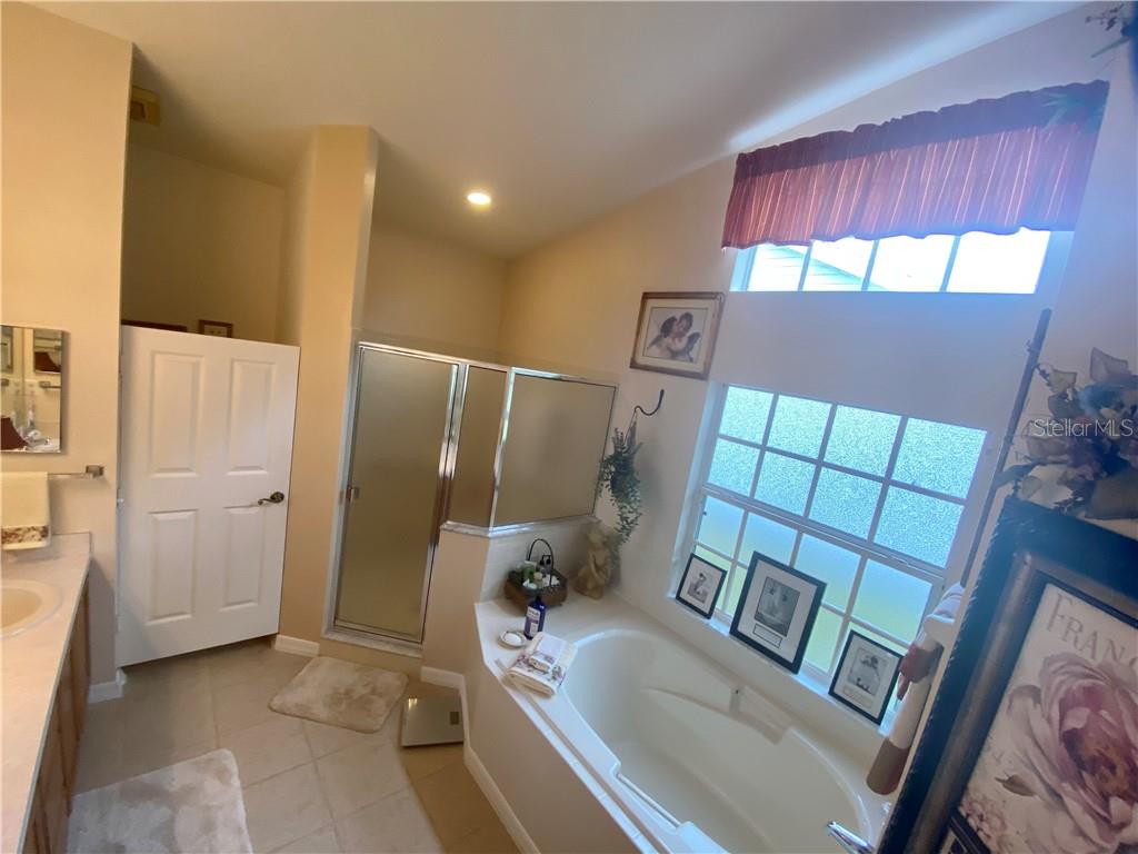 OVERVIEW OF FULL MASTER BATH  NOTICE THE TRANSOM WINDOW ABOVE THE GARDEN TUB BRINGING IN LOTS OF NATURAL LIGHT
