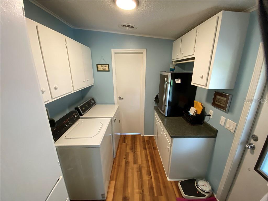LOTS OF FRESHLY PAINTED CABINETS IN SPACIOUS INSIDE UTILITY