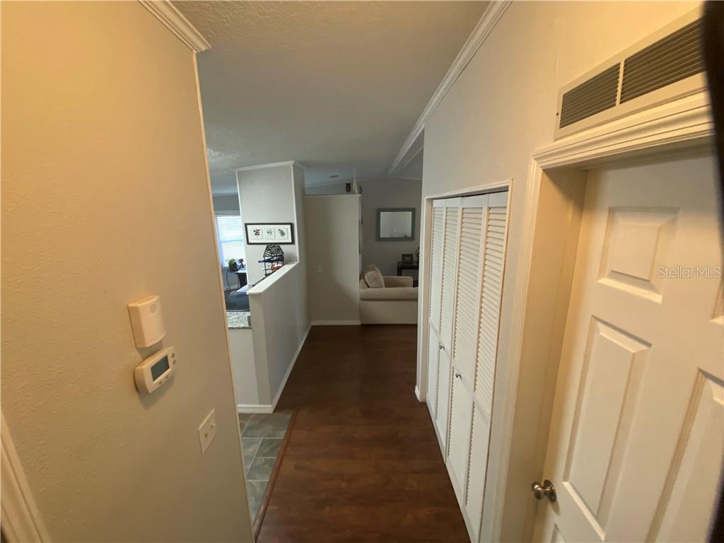 HALLWAY WITH LARGE STORAGE CLOSET AND NEW THERMOSTAT