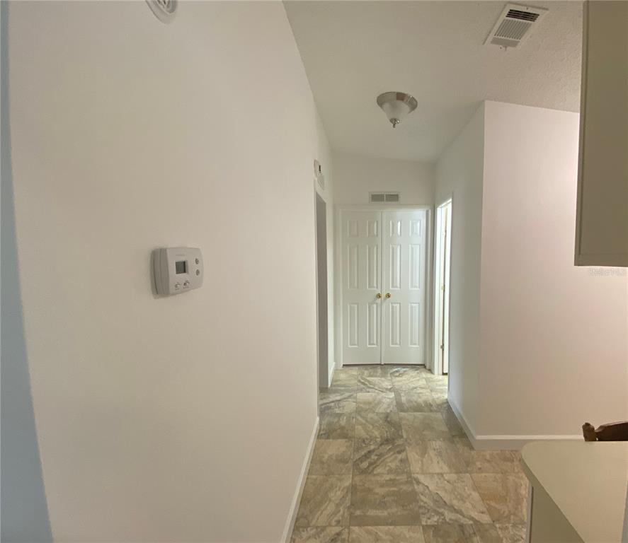 LOOKING DOWN HALLWAY TO DOUBLE DOORS TO MASTER