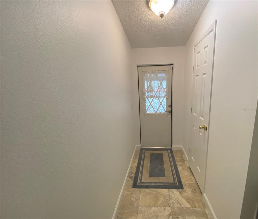 BACK DOOR LEADING TO CARPORT.  NOTICE THE STORAGE CLOSET