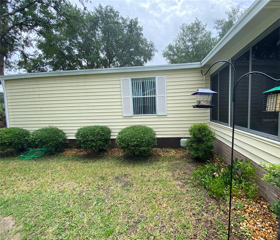 BACK SIDE OF LANAI AND WINDOW TO GUEST BEDROOM