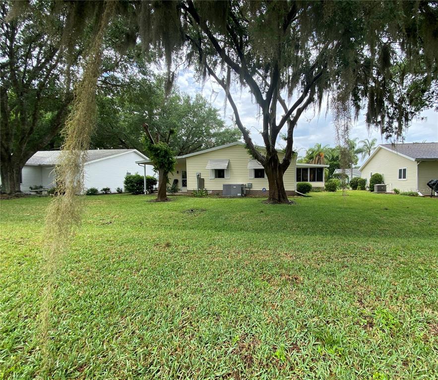 REAR VIEW OF HOUSE LOOKING AT THE TWO WINDOWS TO THE MASTER BEDROOM