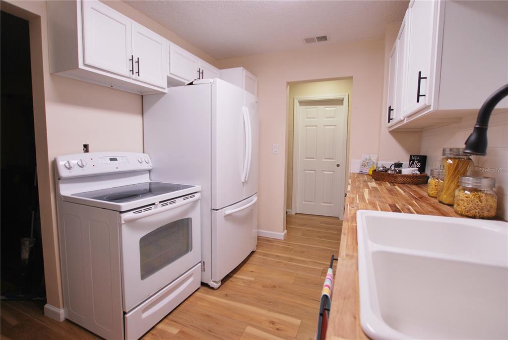 New cabinets, sink, and faucet. Oh, and let's not forget the stunning butcher-block countertop!