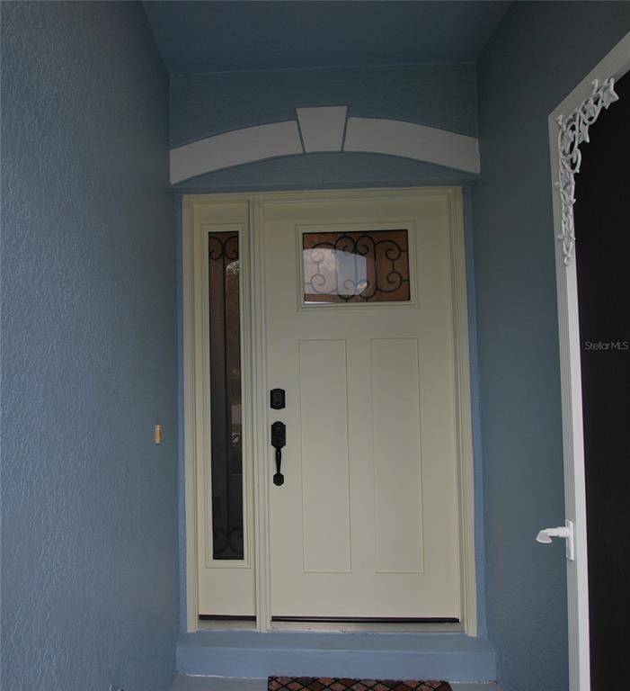 Upgraded front door, with screened-in porch.