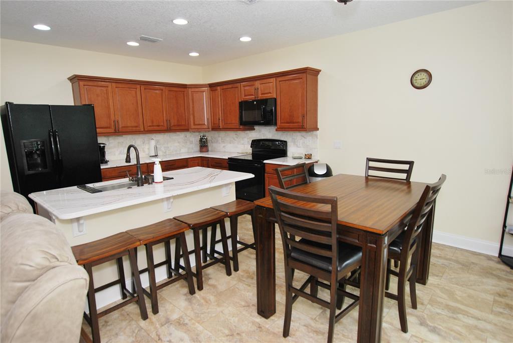 Kitchen big enough for two! Quartz countertops & Natural Stone Backsplash add a luxe touch.