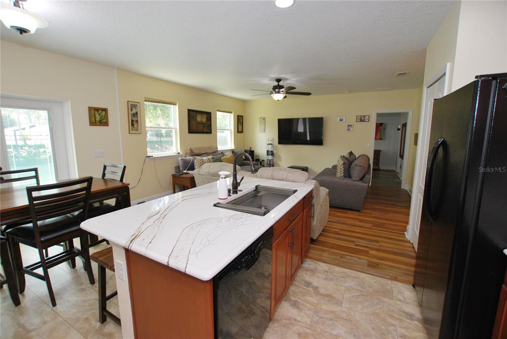 Sink on island open to guests in dining or view to back. Notice the Brushed Stainless Steel Single Bowl Workstation Kitchen Sink!
