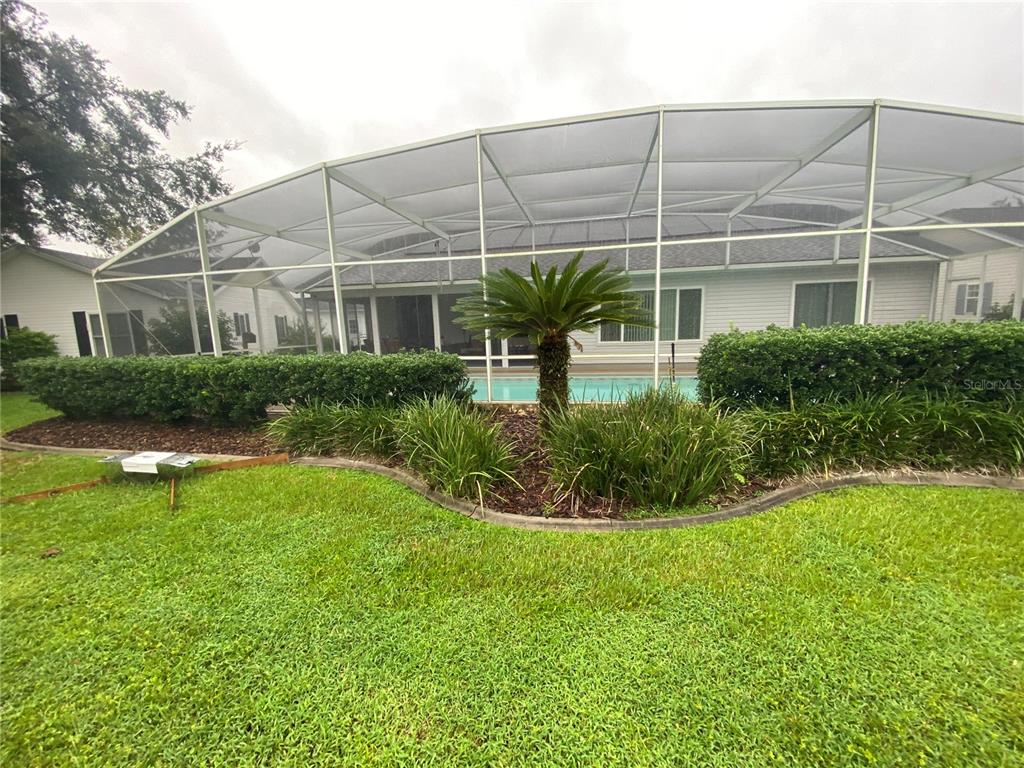 BEAUTIFUL BIRDCAGE AND LANDSCAPING AROUND POOL