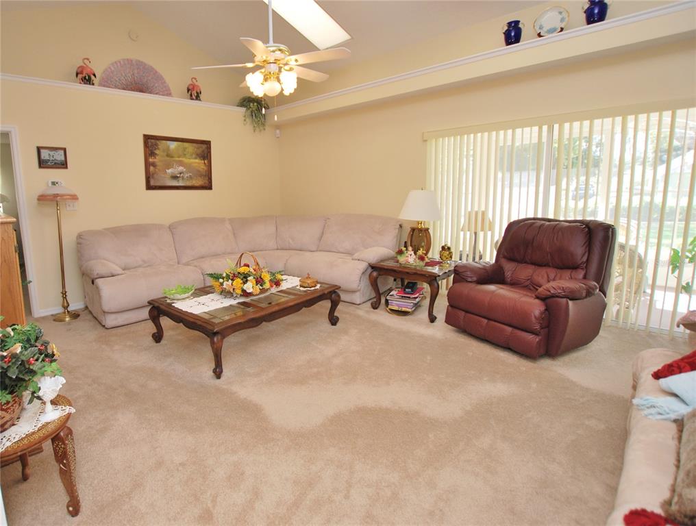 Huge living room with lots of windows, 2 skylights, with open plan to kitchen. Has sliding doors to access enclosed lanai.