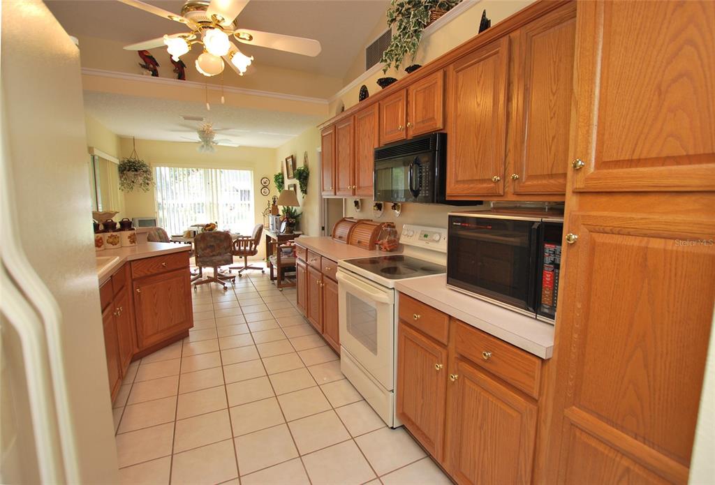 Kitchen with solid wood cabinetry, open to living room, formal dining room, and breakfast nook.