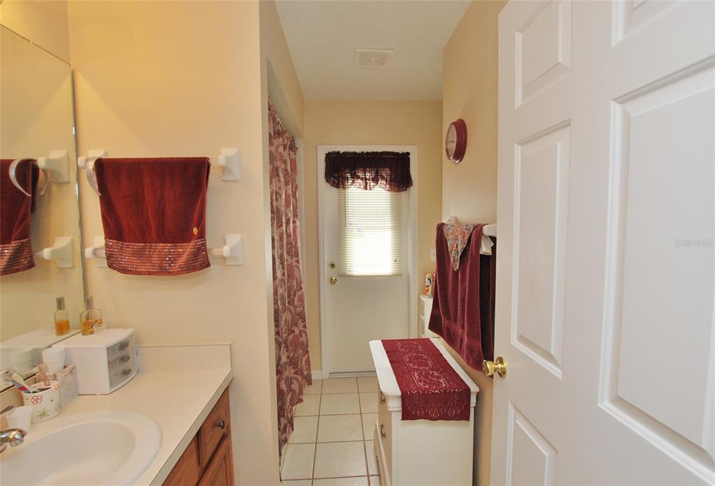 Guest Bath has bathtub and a tucked-in water closet. Already has door accessing the back-yard in case you want to build a pool!