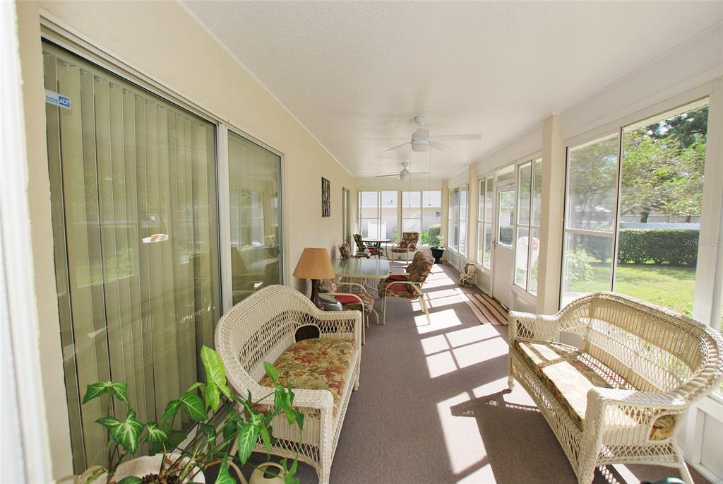 Imagine yourself drinking your morning coffee in this large enclosed lanai. It has two ceiling fans and a nice, cozy rug underfoot.