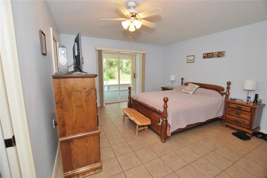 MASTER BEDROOM HAS SLIDING DOORS THAT ACCESS SCREEN=IN PORCH
