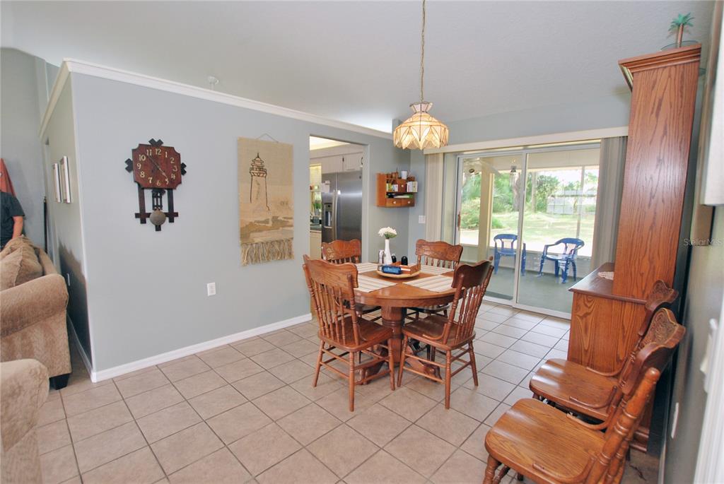 DINING HAS ACCESS TO KITCHEN AND DOUBLE DOORS TO SCREENED-IN PORCH