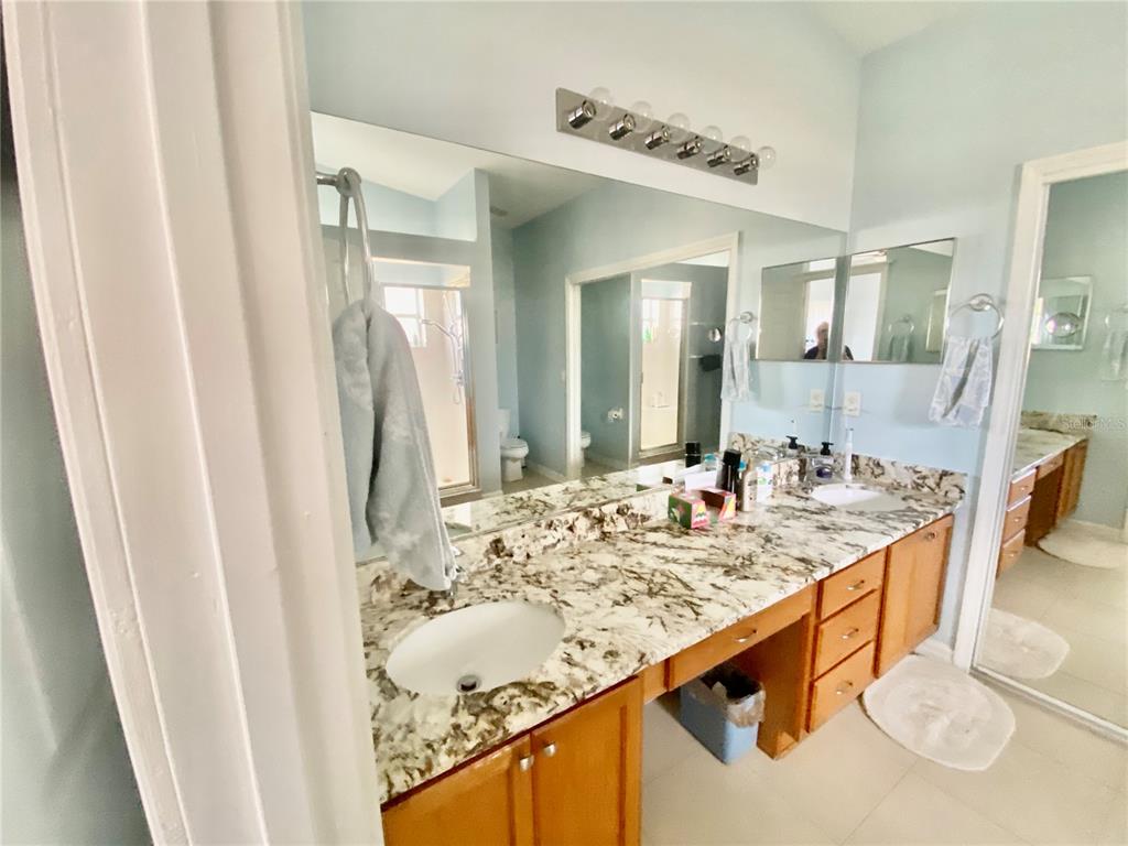 MASTER BATH VANITY WITH DOUBLE SINKS, UPGRADED GRANITE COUNTERTOPS, AND MAKEUP DESK AREA