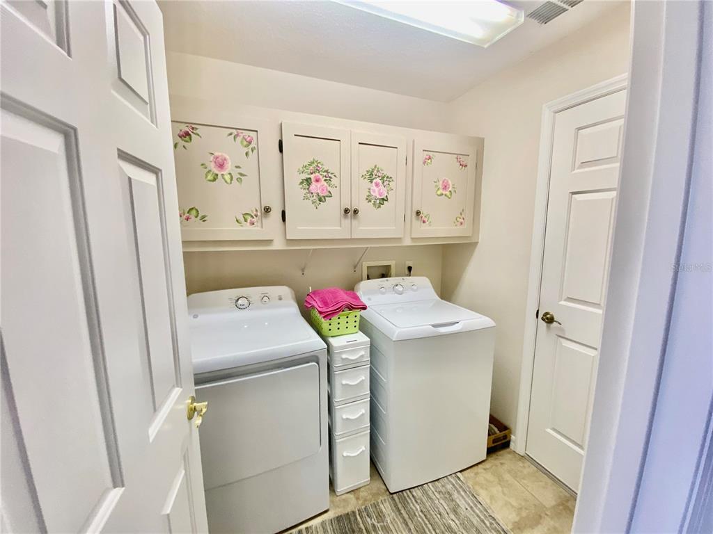 LAUNDRY ROOM WITH NEWER TILE AND NEWER WASHER/DRYER
