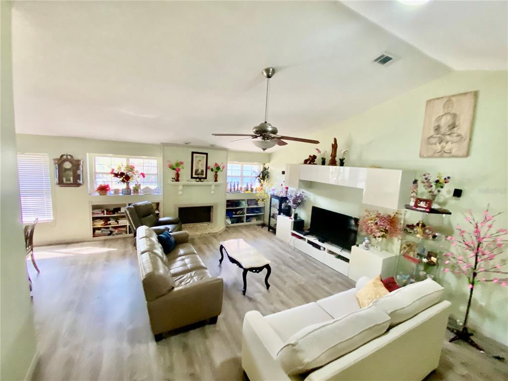 BUILT IN BOOKCASES FLANK BOTH SIDES OF FIREPLACE