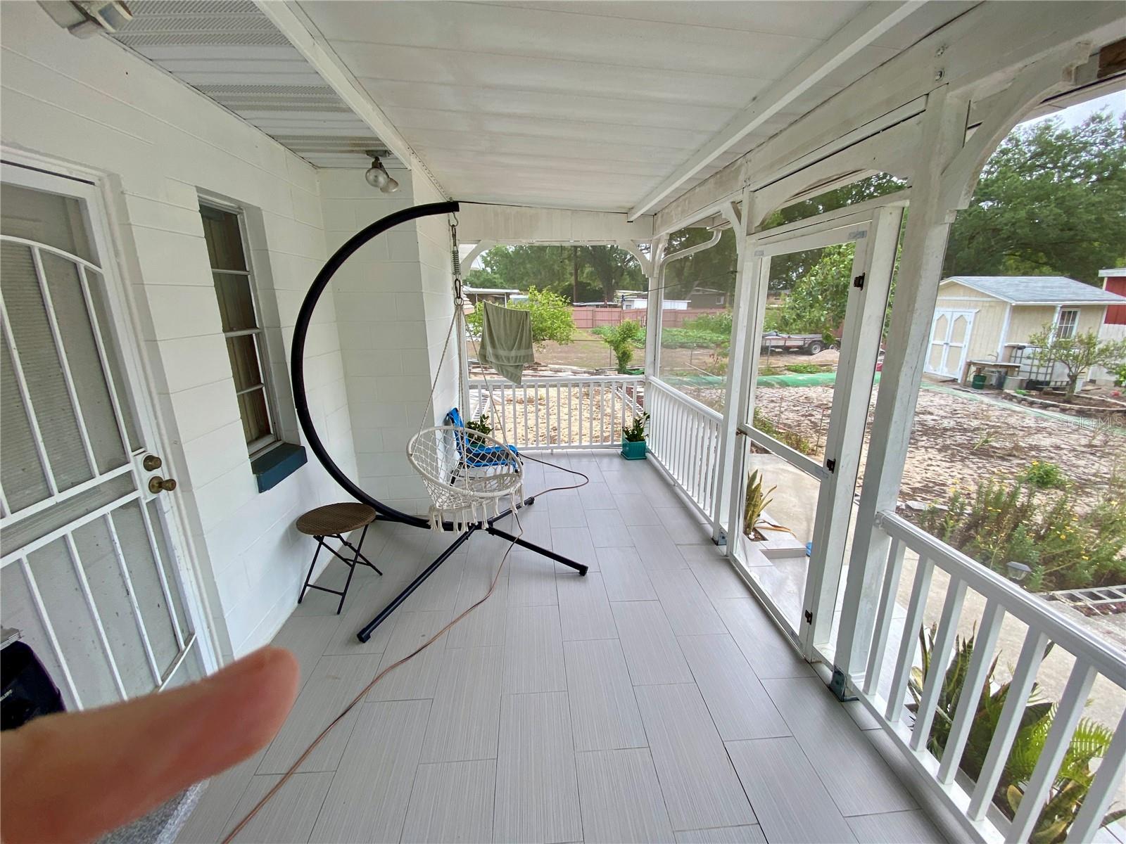 NICELY TILED FLOOR ON BACK PORCH