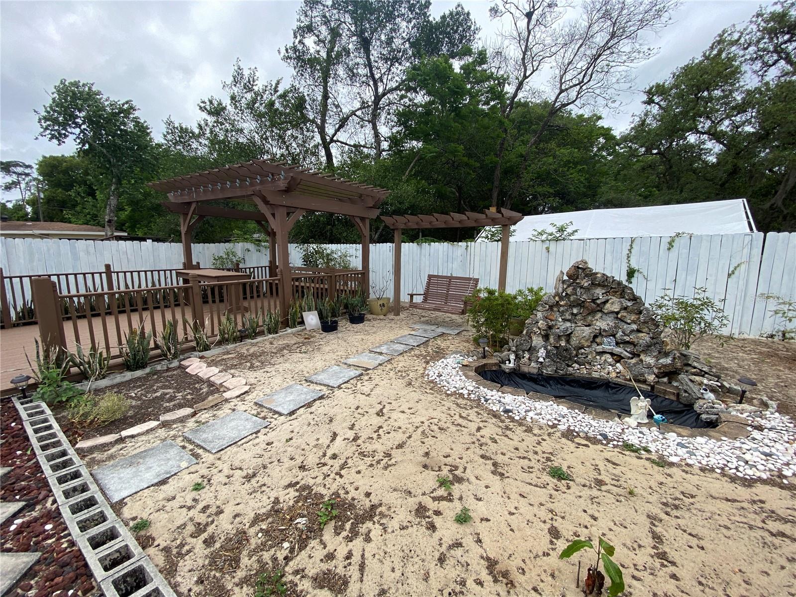 PATHWAY TO SWING, WATER FEATURE, AND BACK DECKING