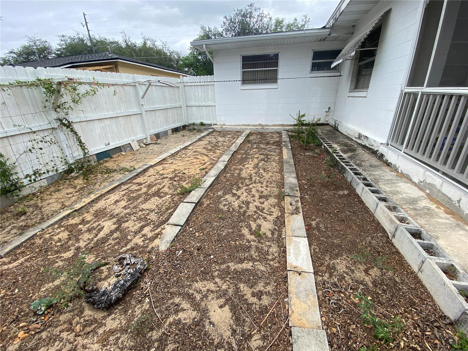 NEATLY ROWED GARDEN AREA ON SIDE