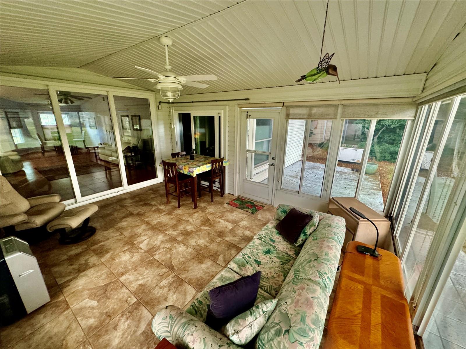 NICELY APPOINTED TILE IN THE LANAI AND THOSE GORGEOUS UPDATED SLIDING DOORS
